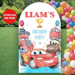 May include: A white arch-shaped birthday party sign with the name "Liam's" in red, and cartoon car illustrations. The sign includes the text "Birthday Party" and a "Custom Made Free Resize" sticker.