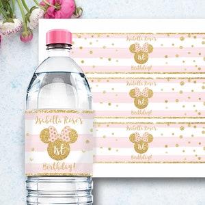 May include: Water bottle label with a pink and gold Minnie Mouse design. The label says "Isabella Rose's 1st Birthday!"