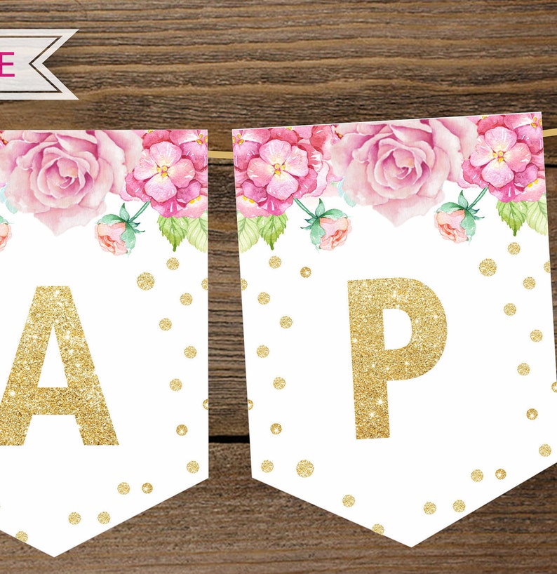 Puede incluir: Una pancarta blanca con dise&ntilde;os florales rosas y letras doradas con purpurina que deletrean "Happy". La pancarta est&aacute; decorada con puntos dorados con purpurina.
