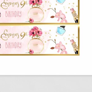 May include: Two pink and gold banners with the text "Emma's 9th Birthday" in gold lettering. The banners feature a pink and white floral design, a bottle of perfume, a compact, and a lipstick.