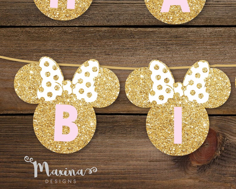 May include: Gold glitter Minnie Mouse ears with pink polka dots and a pink letter "B" in the center. The ears are strung together with a white string.