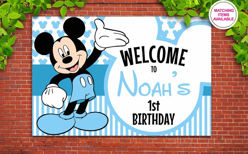 May include: A blue and white welcome sign featuring Mickey Mouse. The sign reads "Welcome to Noah's 1st Birthday".