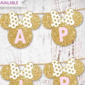 May include: Gold glitter Minnie Mouse ears with pink polka dots and a pink bow. Each ear has a pink letter on a gold circle. The letters spell out "APRIL".