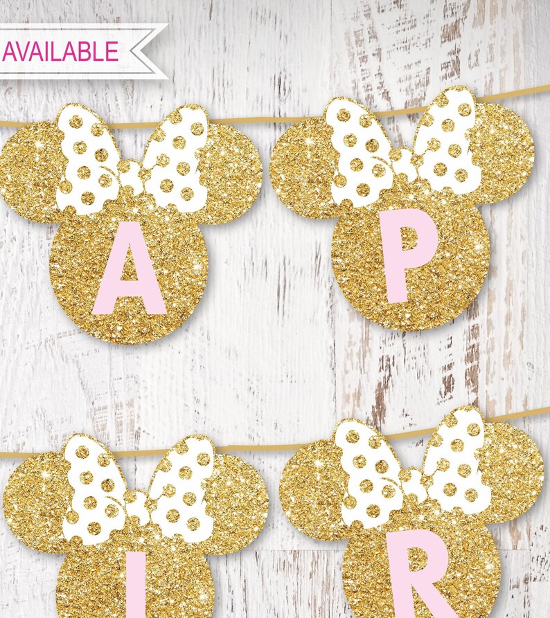 May include: Gold glitter Minnie Mouse ears with pink polka dots and a pink bow. Each ear has a pink letter on a gold circle. The letters spell out "APRIL".