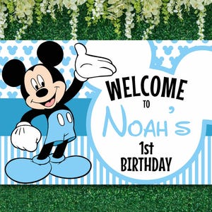 May include: Blue and white welcome sign featuring Mickey Mouse. The sign reads "Welcome to Noah's 1st Birthday".