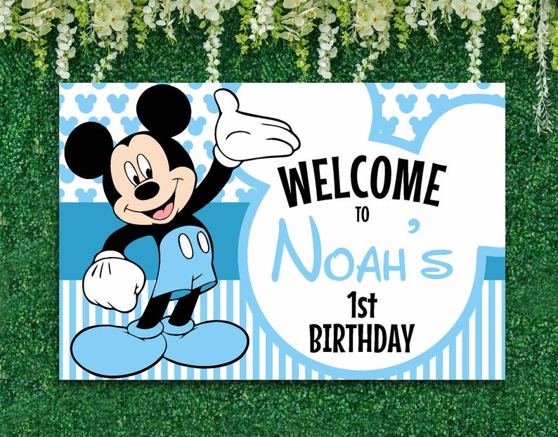 May include: Blue and white welcome sign featuring Mickey Mouse. The sign reads "Welcome to Noah's 1st Birthday".