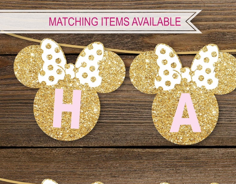 May include: Gold glitter Minnie Mouse ears with pink letters spelling "Happy" on a wooden background. Matching items available.