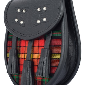 May include: A black leather sporran with a red, yellow, and green tartan flap and three black tassels. The sporran has two Celtic knot designs with silver studs.