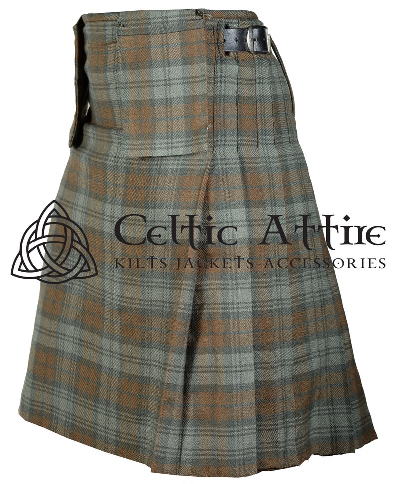 May include: A brown and green plaid kilt with pleats and a belt. The kilt is made of a woven fabric and has a traditional Scottish design. The text "Celtic Attire Kilts-Jackets-Accessories" is printed on the kilt.