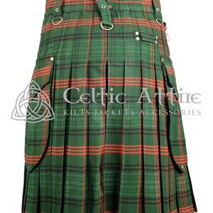 May include: A green and red tartan kilt with a utility pocket on each side. The kilt has a leather strap with metal buckles and rings. The kilt is pleated and has a red trim. The text "Celtic Attire Kilts - Jackets - Accessories" is printed on the kilt.