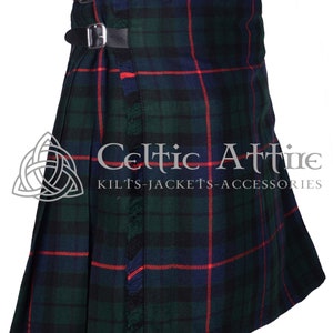 May include: A traditional kilt with a green, blue, and red plaid pattern. The kilt has a leather strap with buckles and a fringed edge.