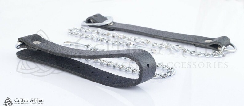 May include: Two black leather straps with metal rings and a silver chain. The straps are about 1 inch wide and the chain is about 1/4 inch thick.