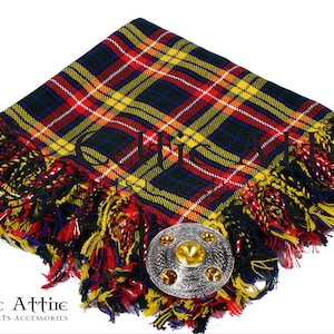 May include: A red, yellow, and blue tartan kilt pin with a silver and gold metal kilt pin. The kilt pin is on a white background.