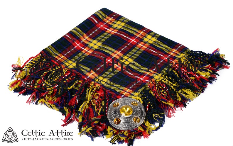 May include: A red, yellow, and blue tartan kilt pin with a silver and gold metal kilt pin. The kilt pin is on a white background.