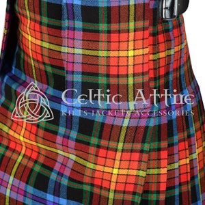 May include: A colorful kilt with a black background and a variety of colors including red, yellow, blue, and green. The kilt is made of a woven fabric and has a traditional plaid pattern. The kilt is worn with a black leather belt.