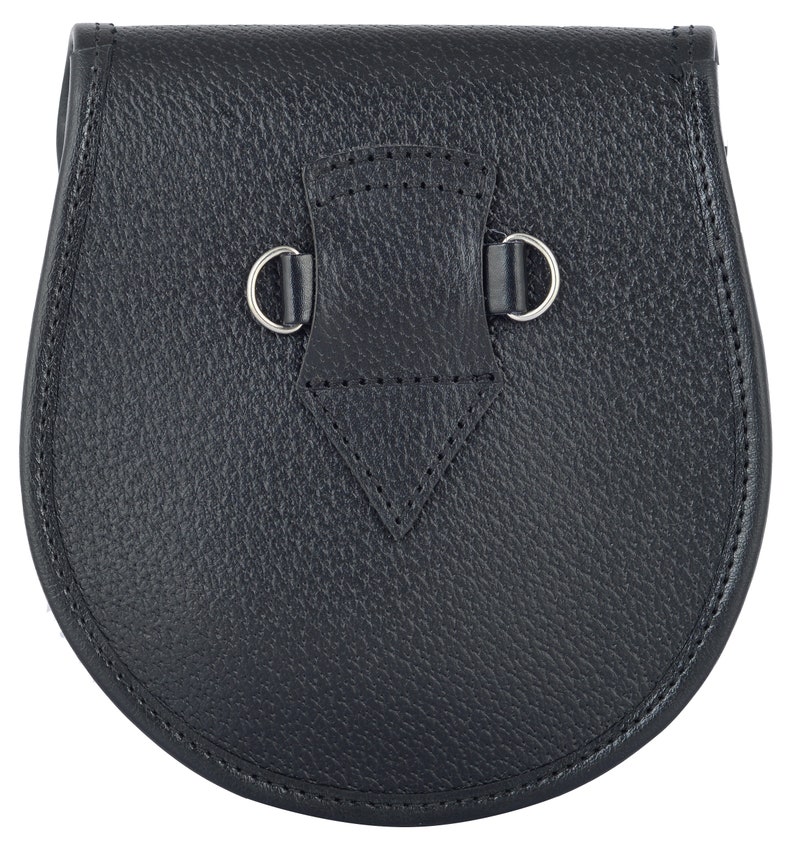 May include: A black leather sporran with a silver buckle and two silver rings.