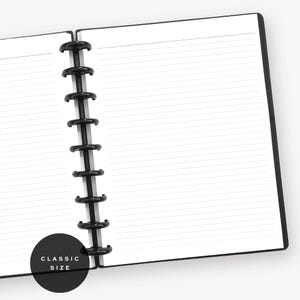 May include: An open disc-bound notebook with white lined paper and a black spine featuring nine black plastic discs. A circular black label in the bottom left corner displays the white text "CLASSIC SIZE" in a clean, sans-serif font.