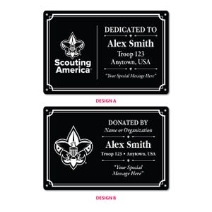 May include: Two rectangular black plaques with white text and borders. Design A features the Scouting America logo, 'DEDICATED TO', 'Alex Smith', 'Troop 123', 'Anytown, USA', and 'Your Special Message Here'. Design B shows the logo, 'DONATED BY', 'Name or Organization', 'Alex Smith', 'Troop 123', 'Anytown, USA', and 'Your Special Message Here'.