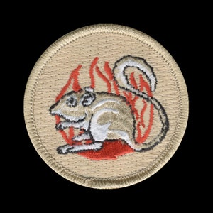 May include: A beige embroidered patch with a white mouse in a red flame design.