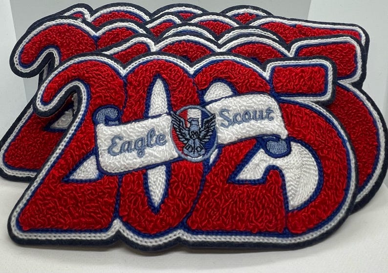 A stack of Eagle Scout Year Letterman Jacket Patches with the year 2025 on top.