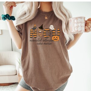 Cute Halloween NICU Nurse Tee with Ghost, Pumpkin and Witch Hat for Neonatal ICU Staff.