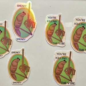 May include: A collection of holographic stickers featuring a cartoonish character with a long arm and a raised finger. Some stickers say "SNEAKY", while others say "YOU'RE KILLING THE VIBE" in a green oval.
