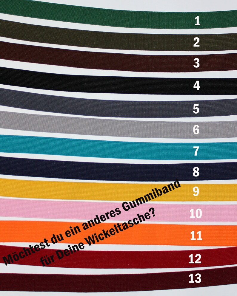 May include: Thirteen different colours of elastic bands, numbered 1 through 13. The text "M&ouml;chtest du ein anderes Gummiband f&uuml;r Deine Wickeltasche?" is written in black on a white background.