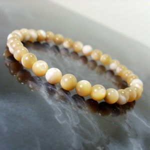 Natural Mother of Pearl Bracelet 6mm or 5mm, Golden beige and Cream Shell Trochus niloticus Beaded Bracelet for Women Men Girl + Gift Bag