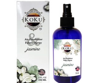 May include: A blue bottle of jasmine scented air freshener and fabric spray with a white label. The label says "KOKU Air Freshener Fabric Spray jasmine" and "8 fl oz 236 ml".
