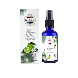 May include: A blue bottle of KOKU bergamot air freshener and fabric spray. The bottle is 4 fl oz (118 ml) and has a white label with a green lime and white flowers. The label also says "Air Freshener & Fabric Spray bergamot".