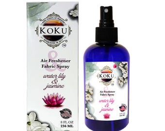 May include: A blue bottle of KOKU water lily & jasmine air freshener and fabric spray. The bottle is 8 fluid ounces or 236 milliliters. The label features a white water lily and jasmine flowers.