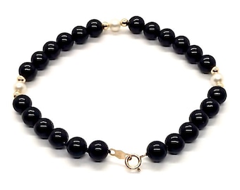 Schwarzer Onyx 6 mm und Süßwasserzuchtperle 4 mm aus 585er Gelbgold. Gelb, 18cm