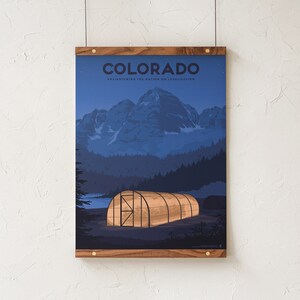 May include: A framed poster with a wooden frame. The poster features a nighttime landscape with mountains, trees, and a greenhouse. The word "COLORADO" is at the top, with the text "Enlightening the Nation on Legalization" below.