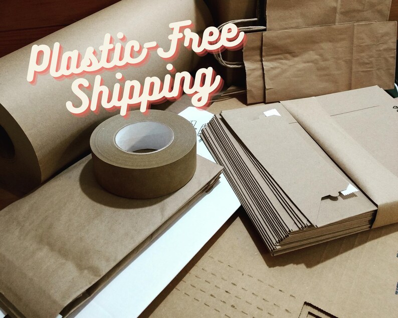 May include: A collection of brown kraft paper shipping supplies including a large roll of paper, a roll of adhesive tape, and a stack of folded paper bags. The text Plastic-Free Shipping is overlaid in white with a red outline across the top left.