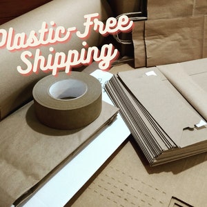 May include: A collection of brown kraft paper supplies including a large roll, a roll of adhesive tape, and stacks of flat paper bags. The text Plastic-Free Shipping is overlaid in a white font with a red outline across the top of the items.
