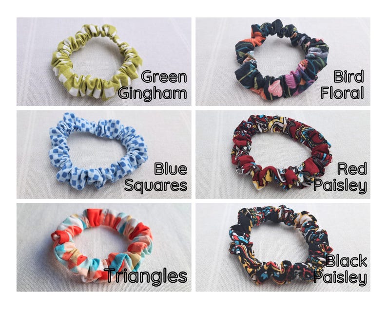 May include: Six fabric hair scrunchies arranged in a grid. Patterns include green gingham, bird floral, blue squares, red paisley, multi-colored triangles, and black paisley. Each scrunchie is labeled with its respective pattern name in black text.