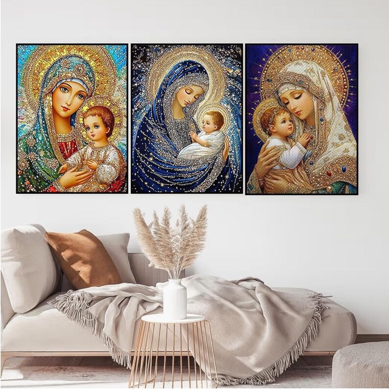May include: Set of three framed religious art prints. Each print depicts a mother and child with halos, in jewel-toned colors. The artwork features intricate details and a sparkling effect, creating a sense of reverence and beauty. The frames are black.