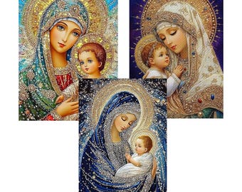 May include: Three religious art prints depicting the Virgin Mary and baby Jesus. The images feature detailed artwork with halos, ornate clothing, and a sparkling, jewel-like effect. The colour palette includes blues, golds, and whites.