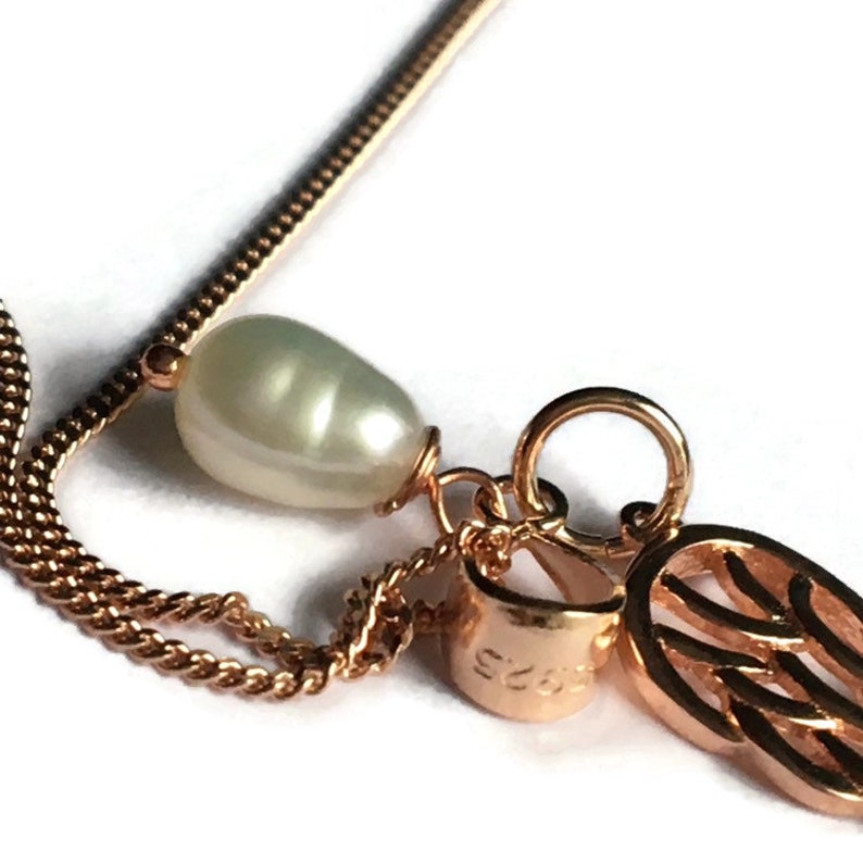 Angel wing and pearl pendant