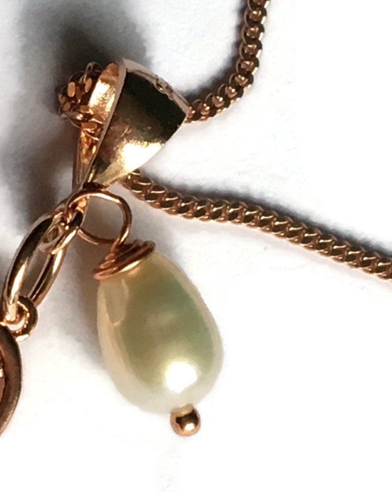 Angel wing and pearl pendant