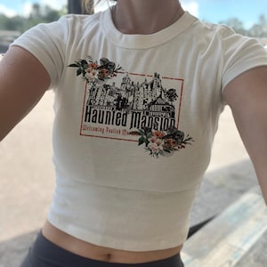 Camiseta para bebé "Mansión Encantada", Top corto "Fantasmas de Autostop", Camiseta "Mortales Insensatos", Camiseta "Fantasmas de Disney", Camiseta floral "Buu to You" para mujer