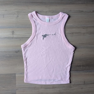 May include: A light pink sleeveless tank top with a crew neckline and ribbed trim. Centered on the chest is a small, black embroidered graphic of a ray gun firing a projectile with the text "pew pew" written in a simple, lowercase font.