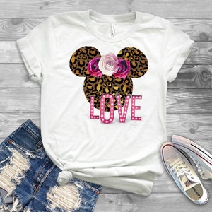 May include: White t-shirt with a leopard print Mickey Mouse head design with pink flowers and the word "LOVE" in pink with white lights.