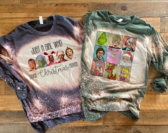 May include: Two long-sleeved shirts with bleach-splattered designs. One shirt is dark gray with the text "Just a girl who loves Christmas movies". The other shirt is green with a grid of nine squares featuring characters from Christmas movies.