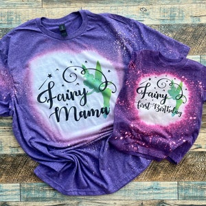 May include: Purple and pink tie-dye t-shirts with a green fairy silhouette and the text "Fairy Mama" and "Fairy first Birthday".
