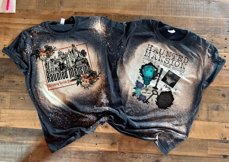 Haunted Mansion with dark florals and skulls on a dark black bleach washed tshirt.