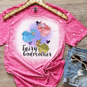May include: Pink bleached t-shirt with a graphic of three fairies and the text "Fairy Godmother".