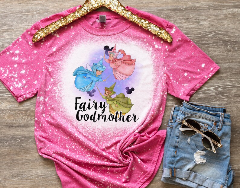 May include: Pink bleached t-shirt with a graphic of three fairies and the text "Fairy Godmother".
