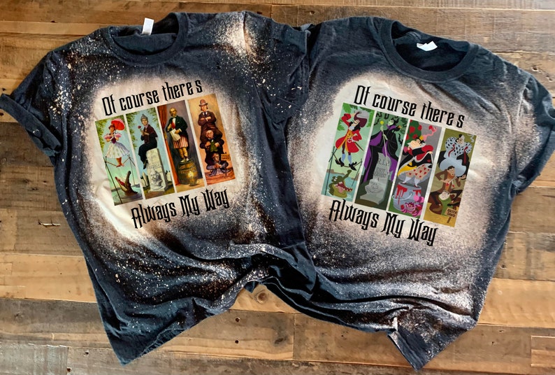 May include: Two black t-shirts with bleach-splattered designs featuring Disney villains. The shirts have the text "Of course there's Always My Way" printed on them.
