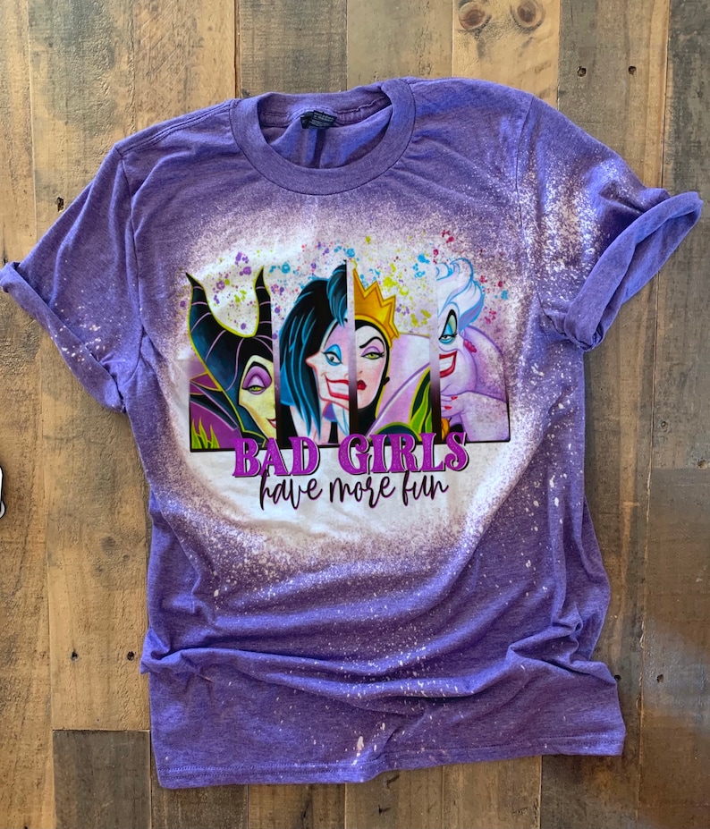 May include: Purple t-shirt with a bleach-splattered design featuring the faces of four Disney villains. The text "Bad Girls have more fun" is printed below the images.